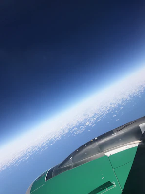 Aerial view of a cargo airplane taking off against a deep blue sky, symbolizing global reach.