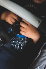 Close-up of a seat belt fastened across a pregnant belly inside a car.