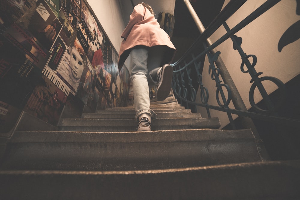 woman in pink jacket on stairs