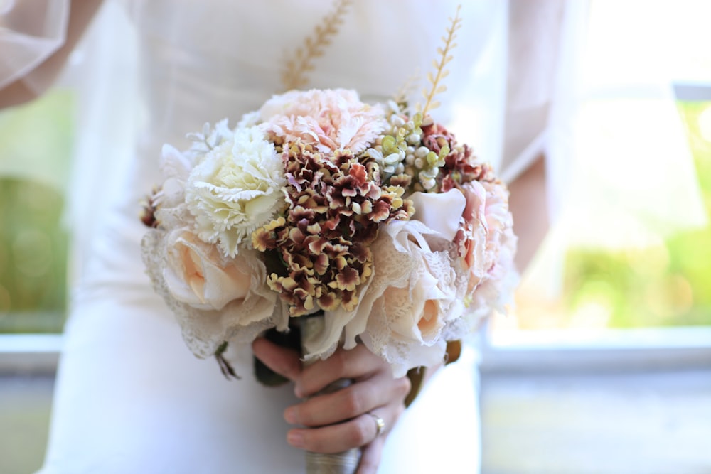 woman holding bouquet of flower