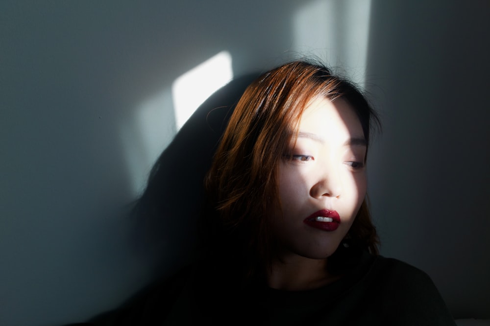 selective focus photography of woman wearing black crew-neck shirt