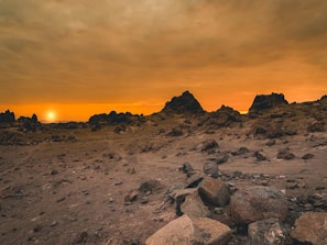 Sunset casting golden hues over the rocky desert landscape near Arad.