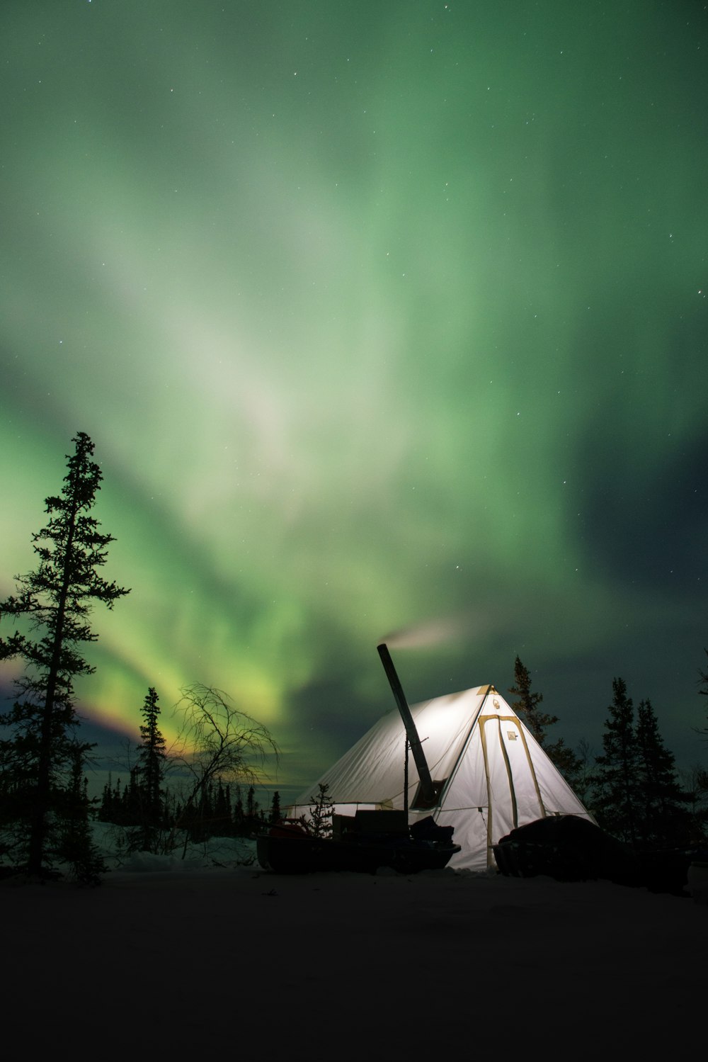 white camping tent and green Arora sky