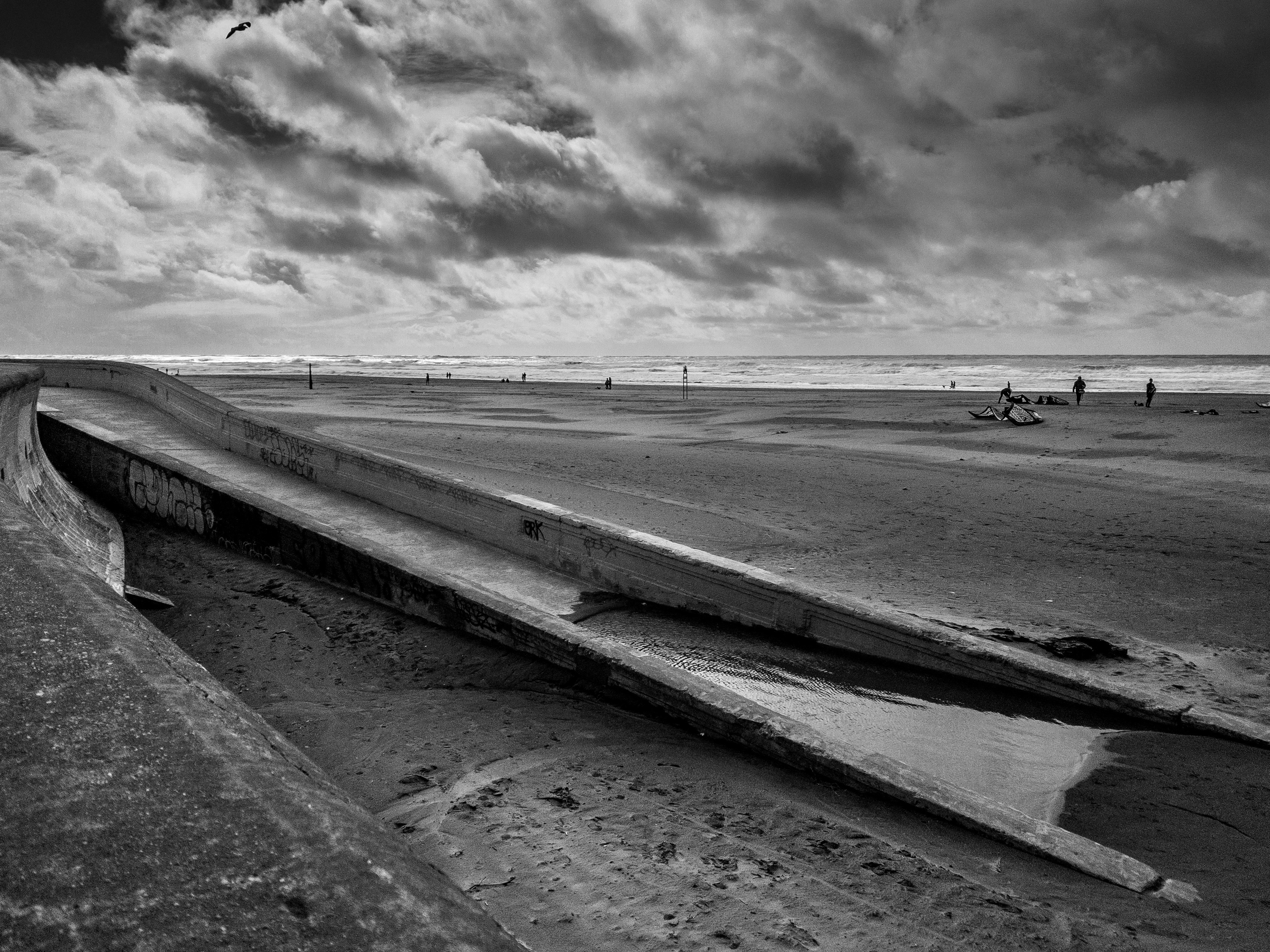 I ran from my house to the beach and discovered this ramp leading down to a puddle.