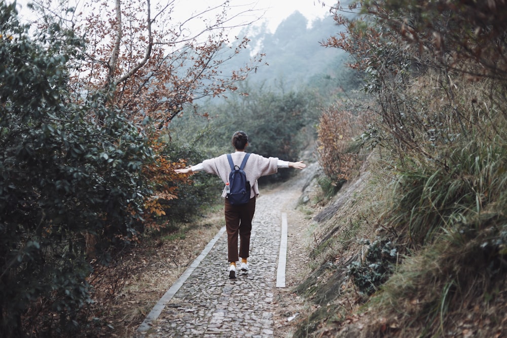 girl standing on pathway during daytime