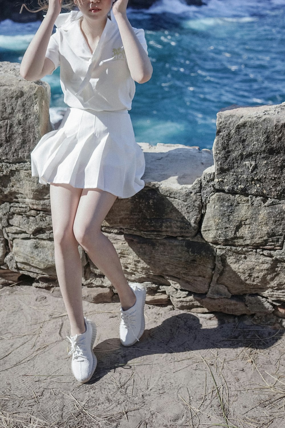 woman sitting on concrete rail