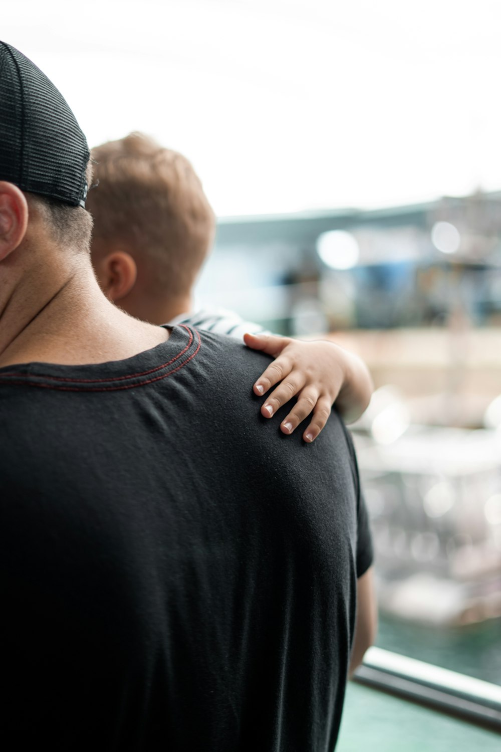 selective focus photography of man carrying baby