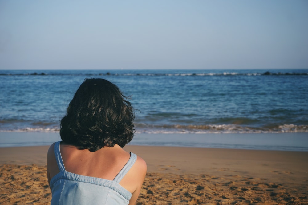 woman sitting near seashore