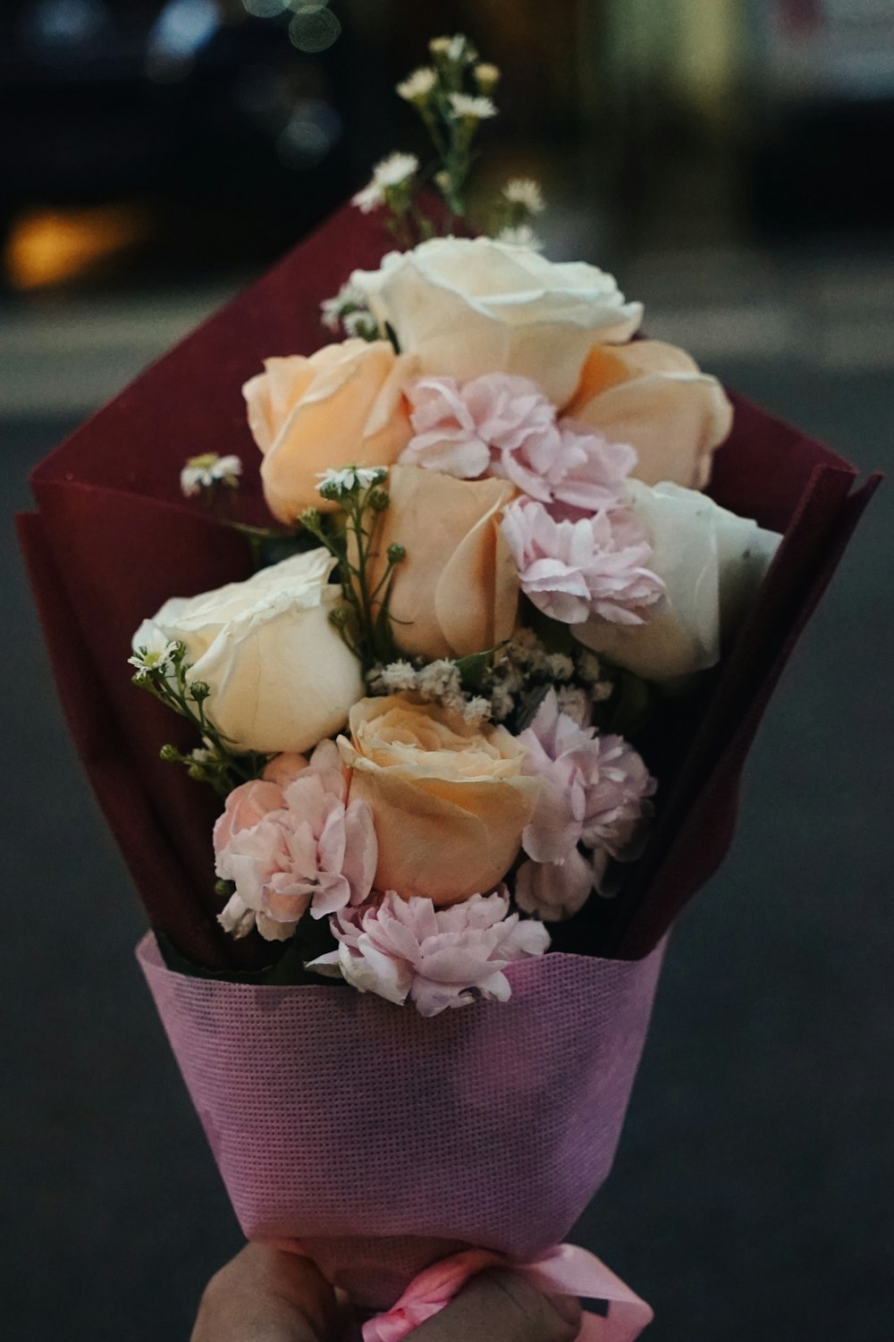 selective focus photography of white and orange rose flower bouquet