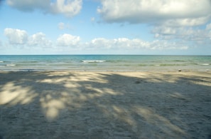 A serene beach scene with gentle waves and soft sand.