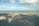 A serene beach scene with gentle waves and soft sand.