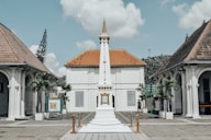 a white building with a clock tower in front of it