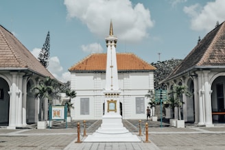 a white building with a clock tower in front of it