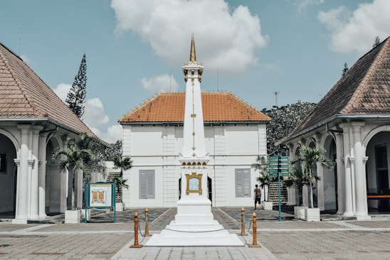 a white building with a clock tower in front of it