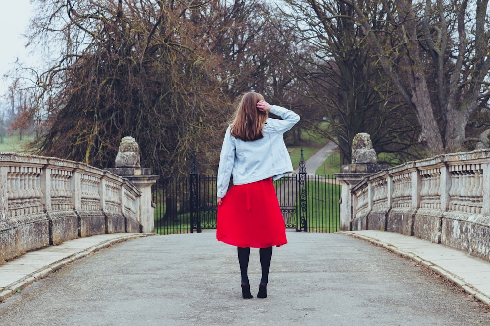 woman standing on bridge during daytime