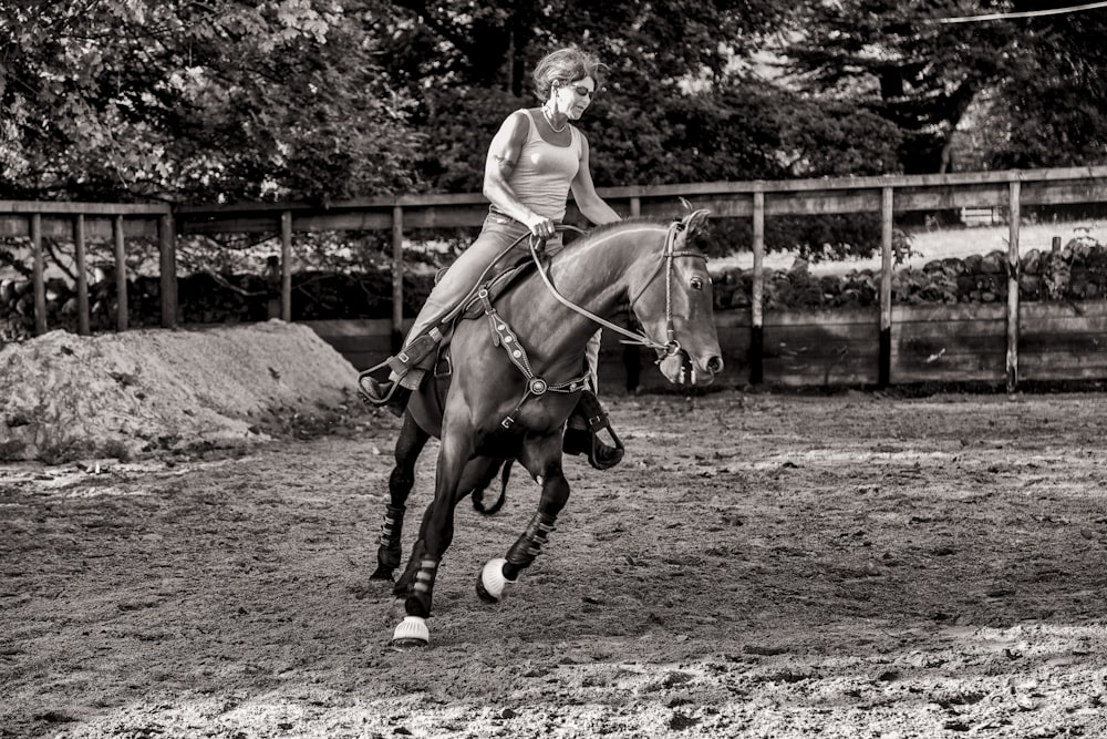 grayscale photography of woman riding horse
