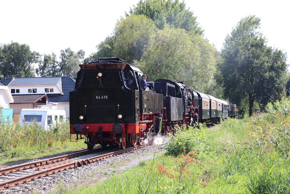 black train near trees during daytime