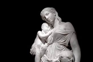 Marble statue symbolizing motherhood, serene and elegant.