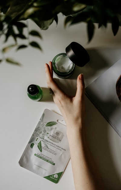 person touching black plastic bottle