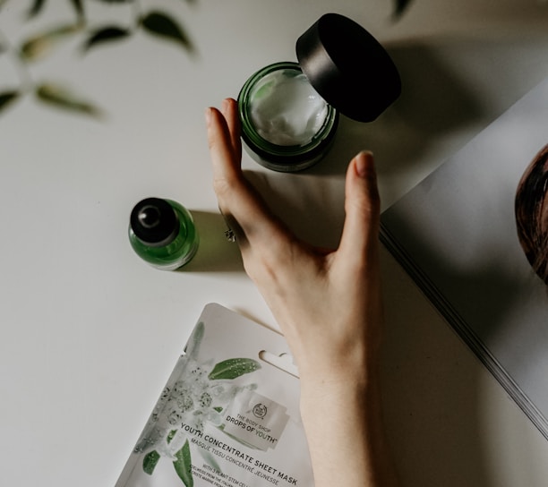 person touching black plastic bottle