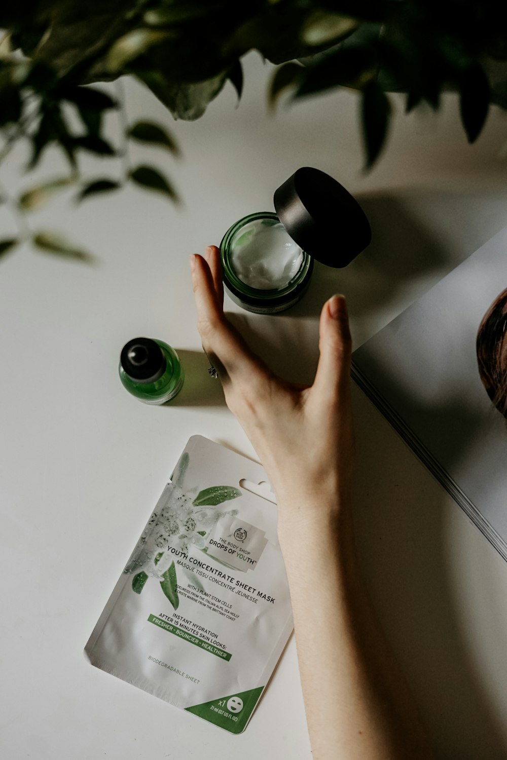 person touching black plastic bottle