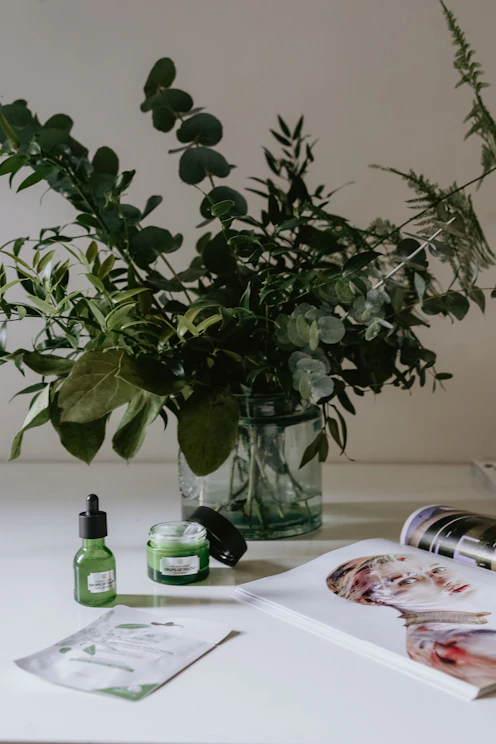 A serene morning scene with soft blush and sage green accents, featuring a cozy skincare setup by a sunlit window.