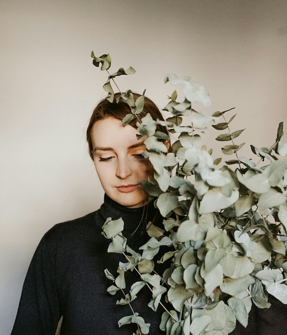 woman holding plant