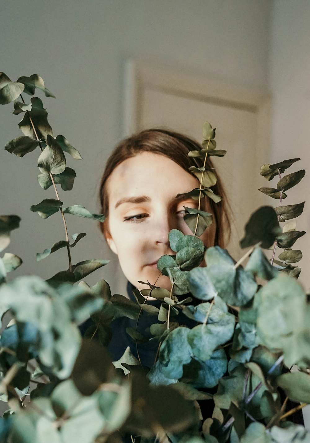 shallow focus photo of woman in front of green plants