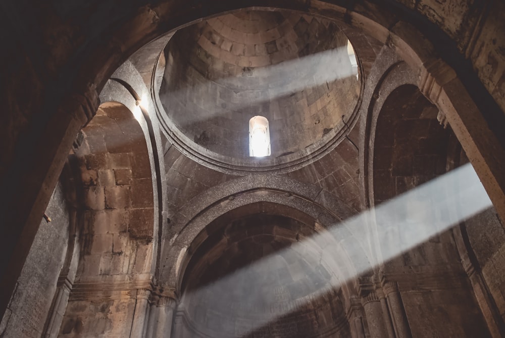 the light shines through a window in a stone building
