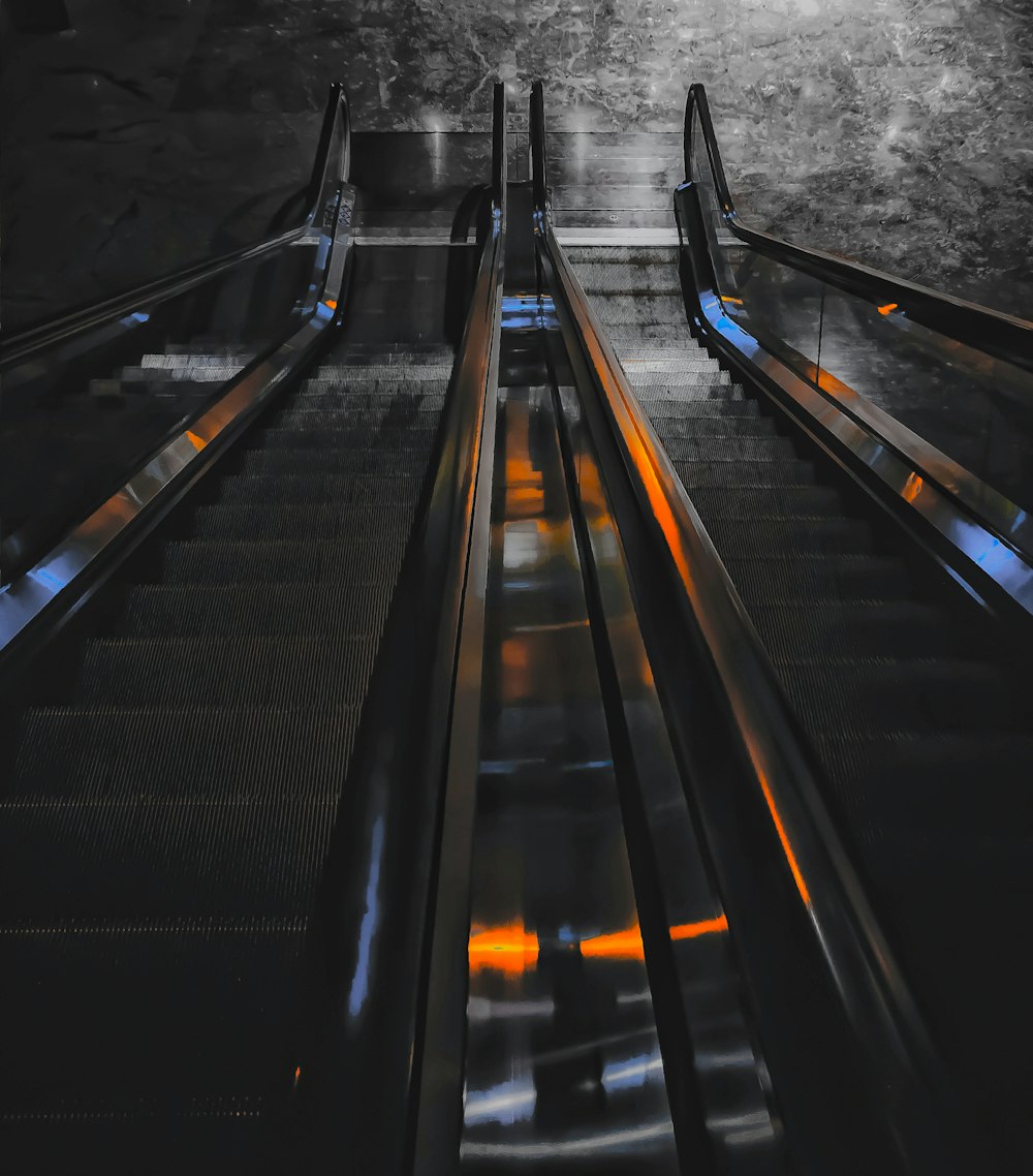 a black and white photo of an escalator