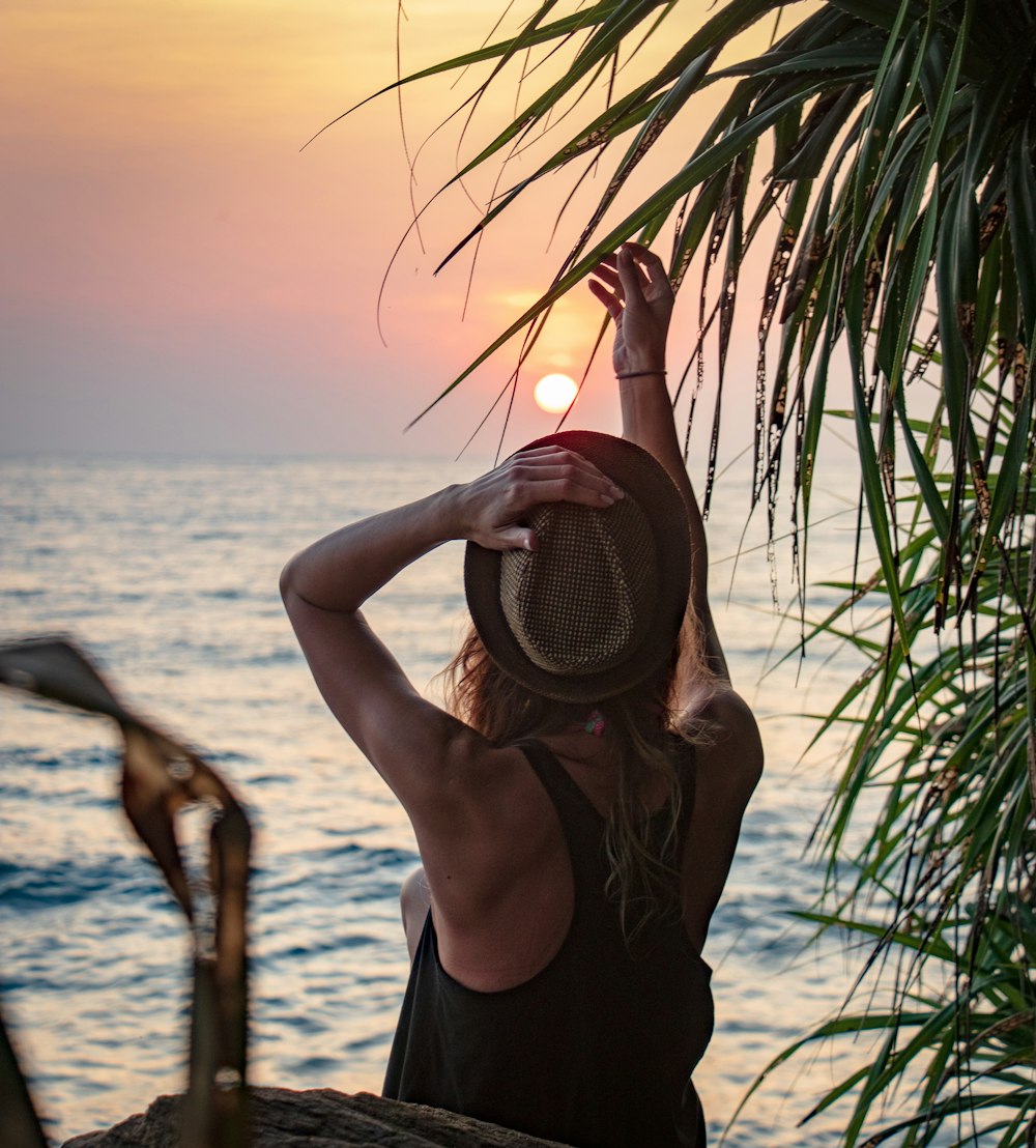 woman wearing bermuda hat and racerback top at the beach