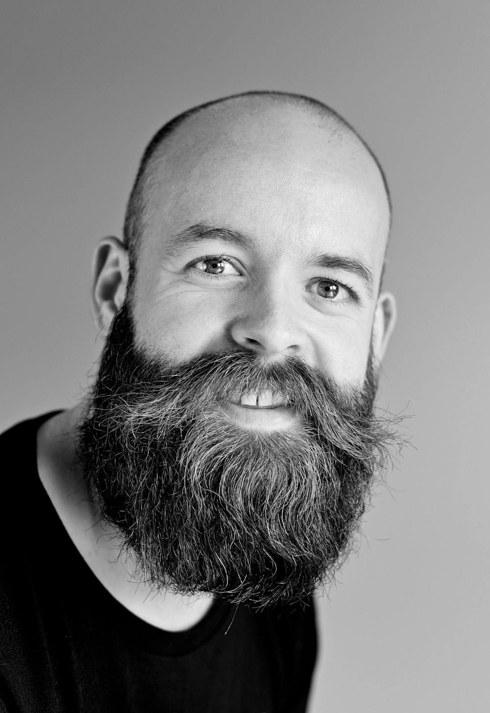 grayscale photography of man wearing crew-neck shirt