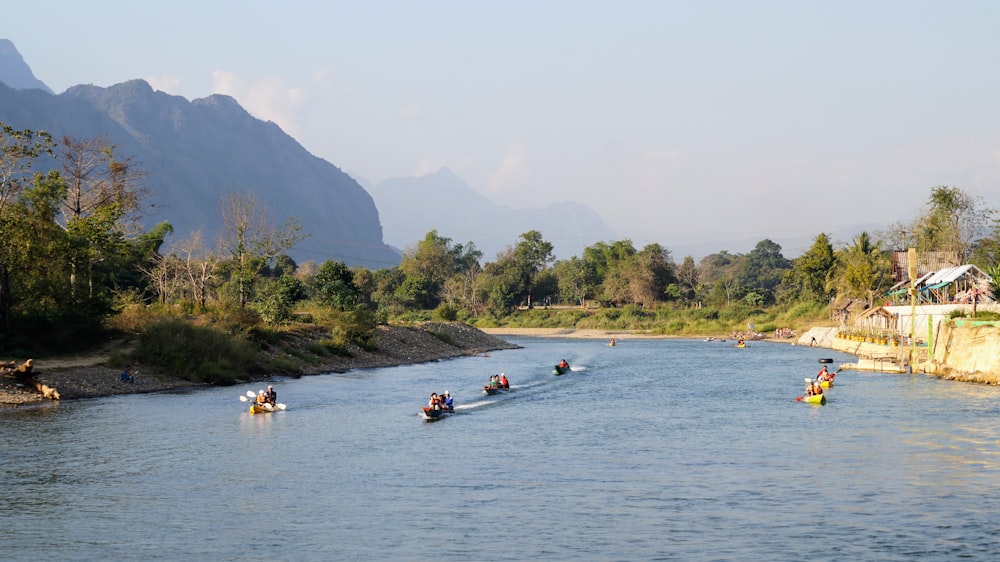 a group of people on small boats in a river