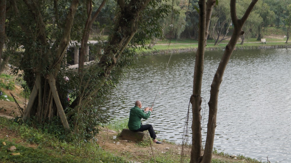 man wearing green dress shirt fishing