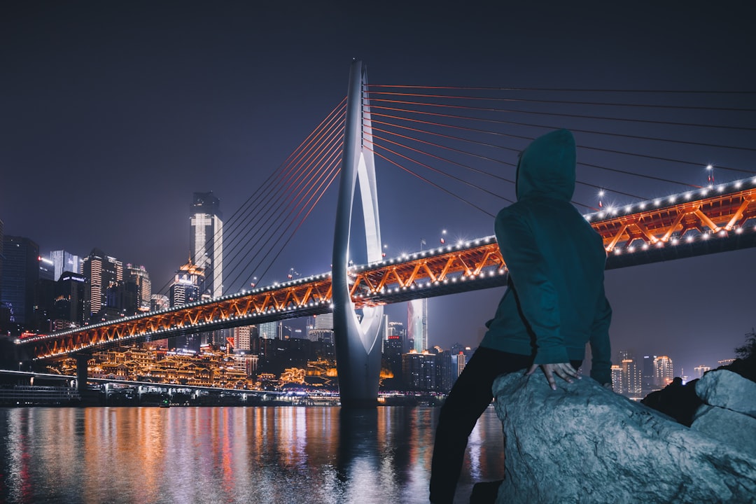 person looking the lighted bridge