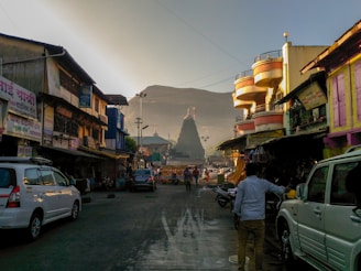 A lively street scene in Assam with people engaging in daily activities under soft morning light