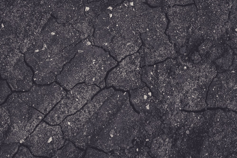 a black and white photo of a cracked surface