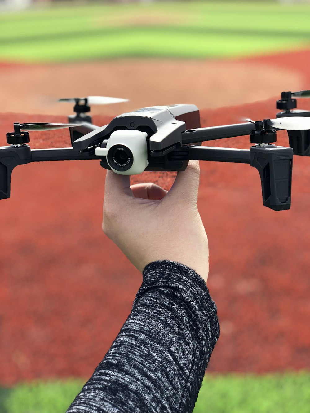 person holding quadcopter drone