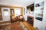 A spacious living room featuring custom built-ins and cozy furnishings.