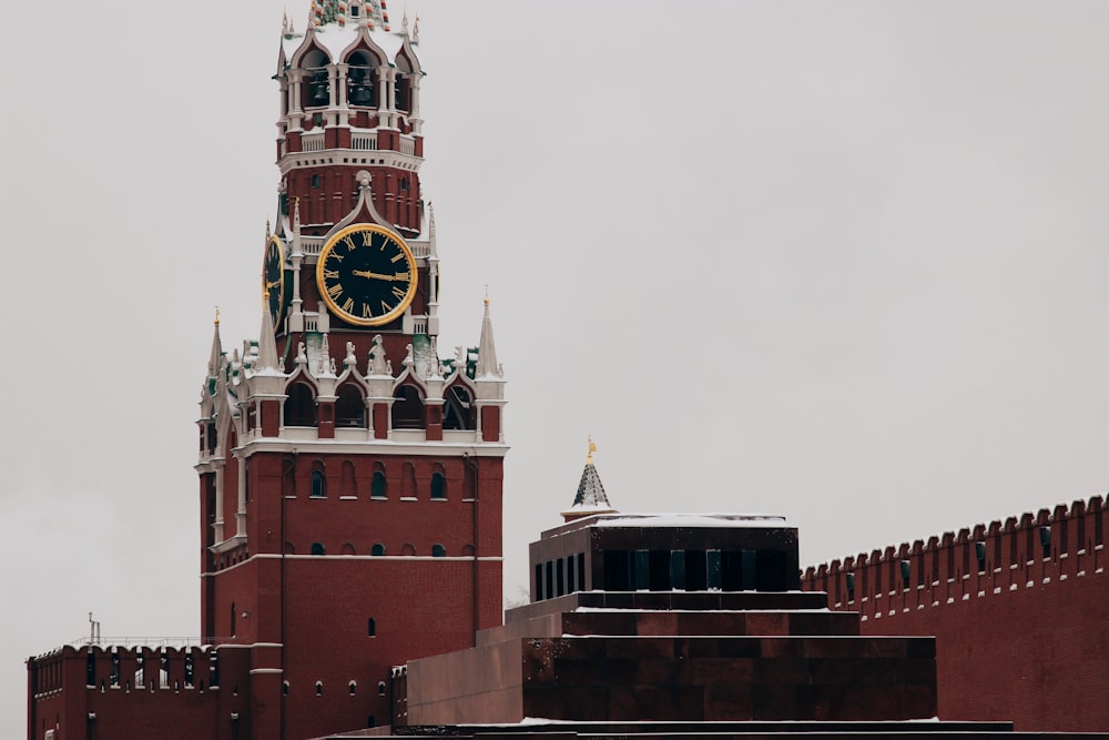 low angle photo of red concrete tower clock