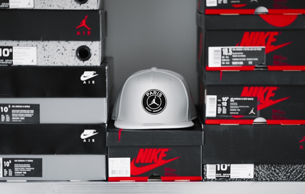 gray Air Jordan cap between Nike and Air Jordan shoe box lot