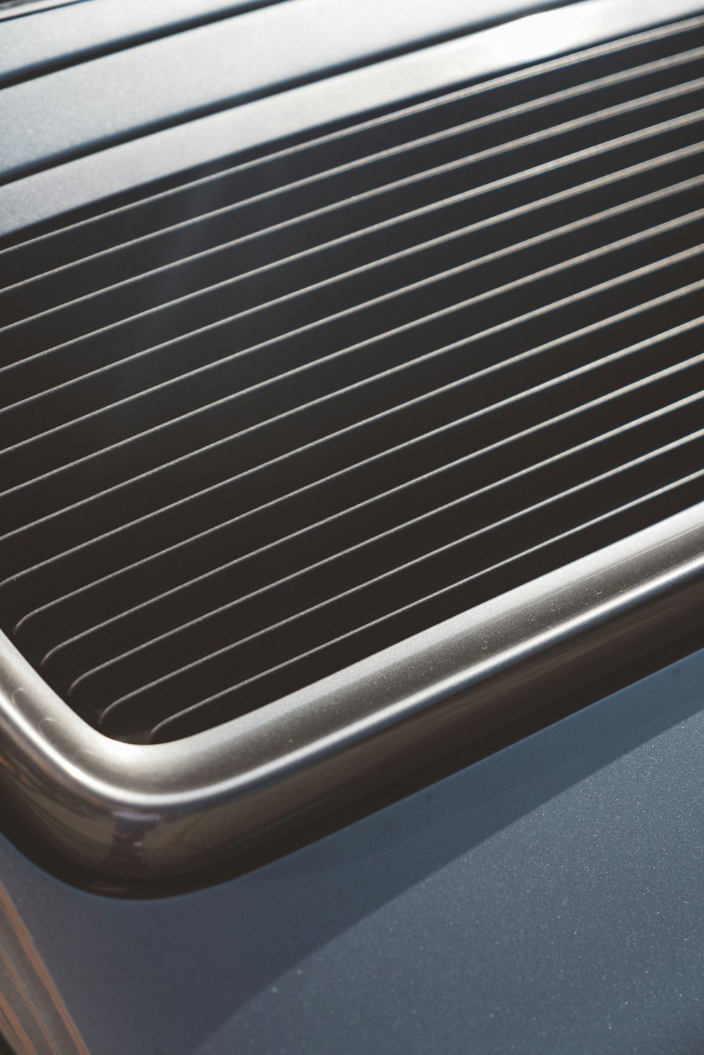 a close up of a metal grill on a car