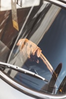 A close-up of a steering wheel with racing gloves.