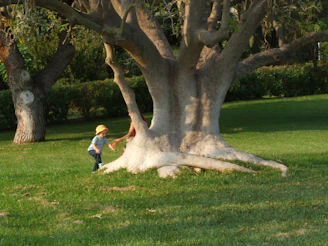 Children happily playing in a park, each sporting a different playful hat from our collection.