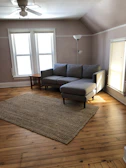 Bright living room with light wood furniture and soft gray textiles.