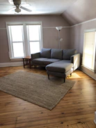 A stylish sectional sofa in a spacious room with natural light highlighting its clean lines.