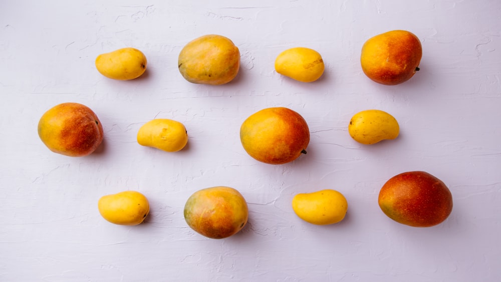 yellow and red fruits on white surface
