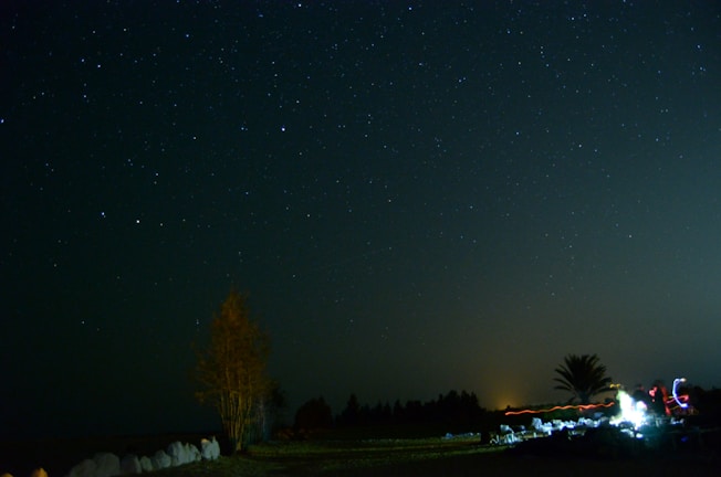 A peaceful landscape with stars shining brightly in the night sky.