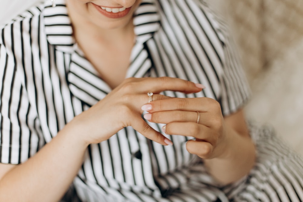 smiling woman holding her ring