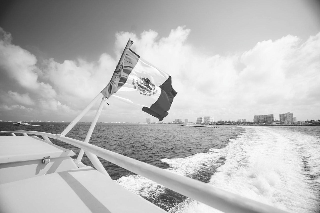 Mexico flag on yellow boat in cancún